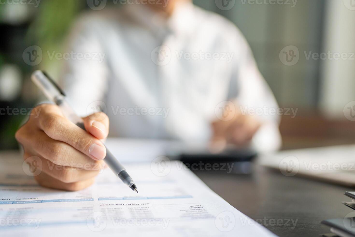 Close up of businessman hands signing or writing document paperwork and report Auditor analysis male professional hand making notes with Business Document. photo