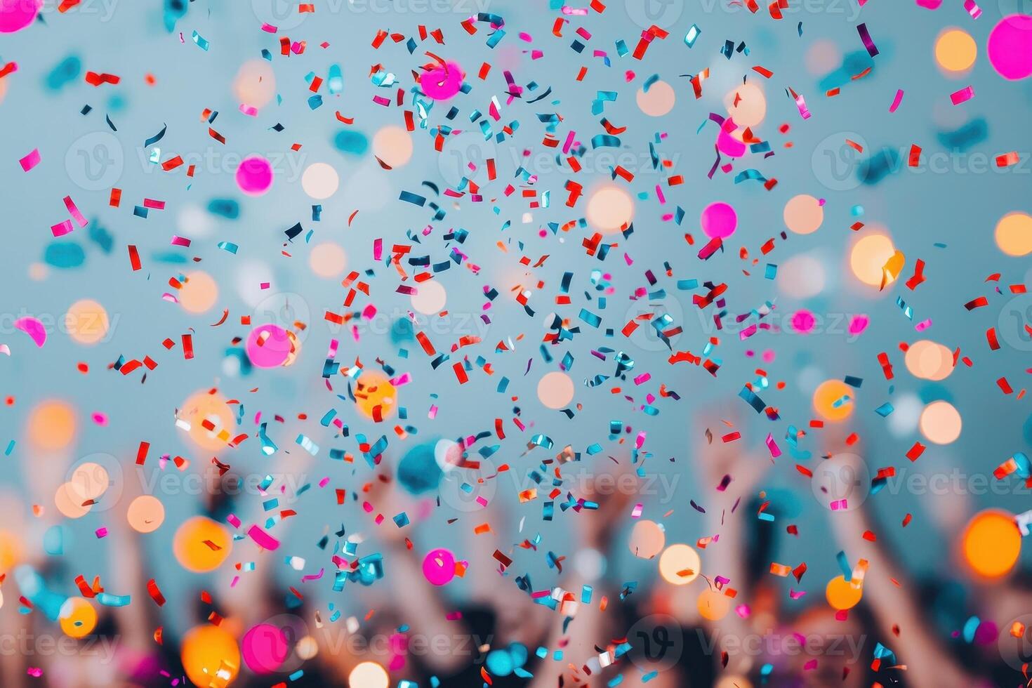 Colorful confetti falling on a cheering crowd at a party. Celebration, festive, and joyful atmosphere. photo