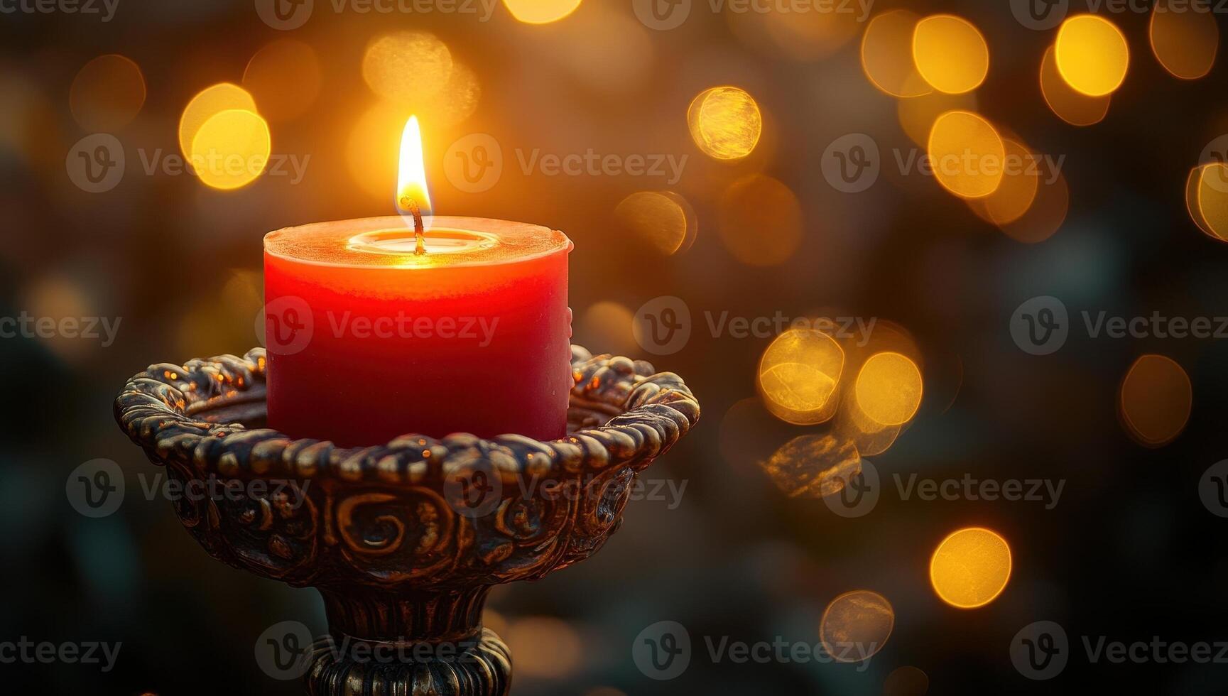 Red candle burning on vintage candlestick holder with bokeh background. Concept of memory, romance, holiday, and celebration photo