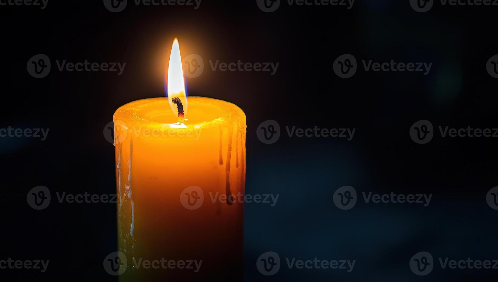 Burning candle flame in the dark. Concept of memory, hope, grief, and remembrance. photo