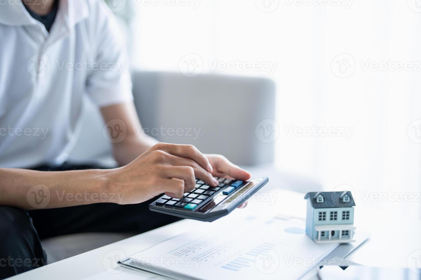 Man calculate finances home pay bills taxes savings economy financial at home photo