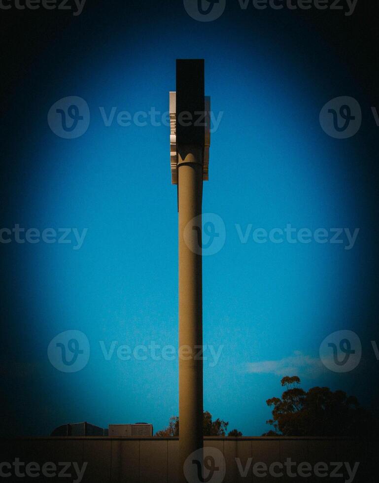Minimalist Vertical Column Structure Against A Deep Blue Sky At Sunset photo