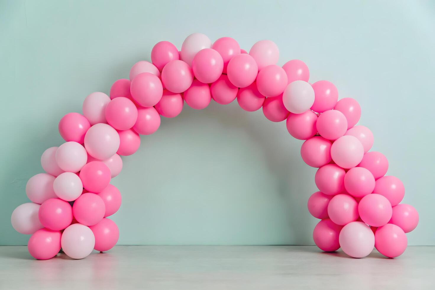 A pink and white arch made out of balloons photo