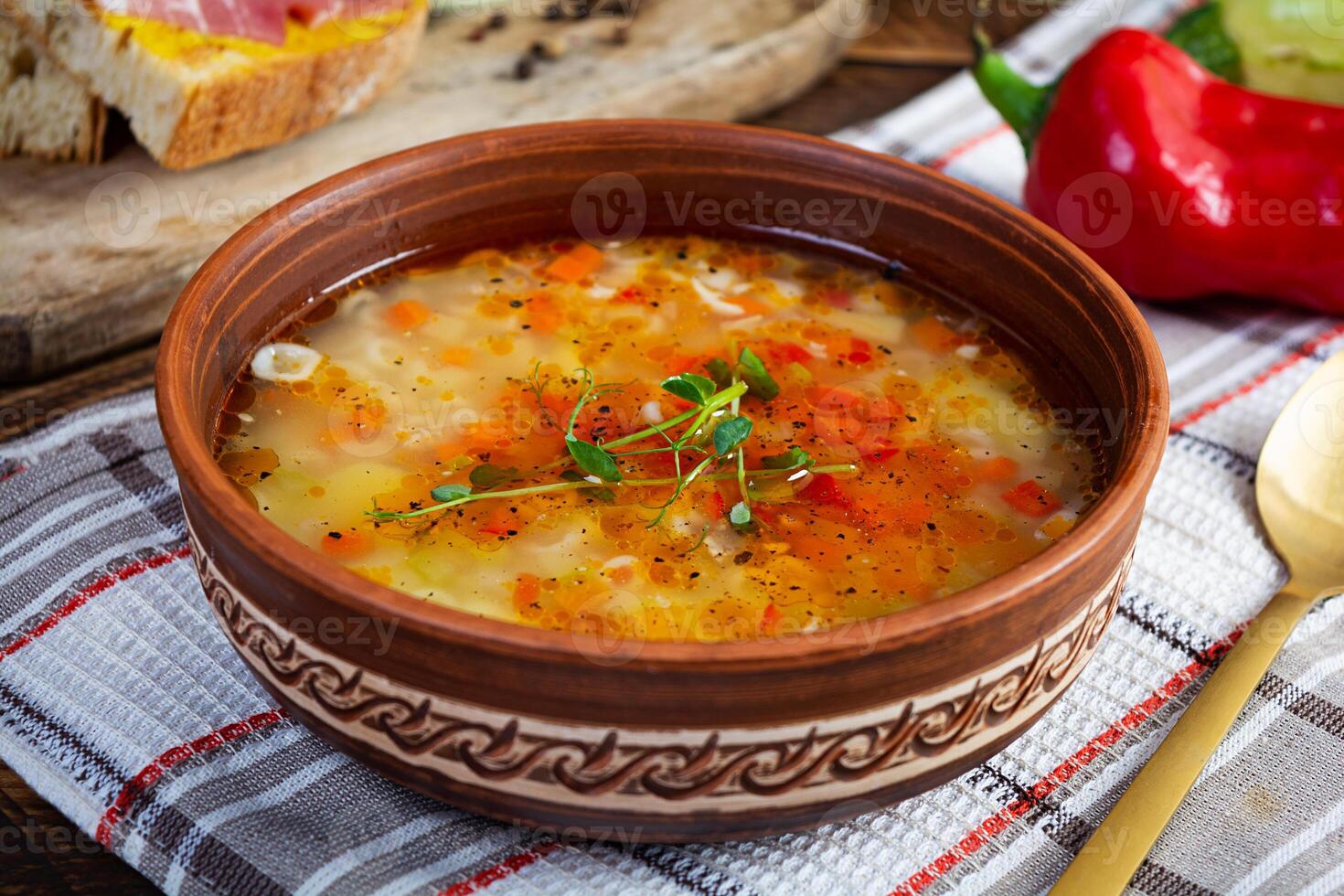 Minestrone soup. Vegetable soup with grilled bread, ham and spices photo
