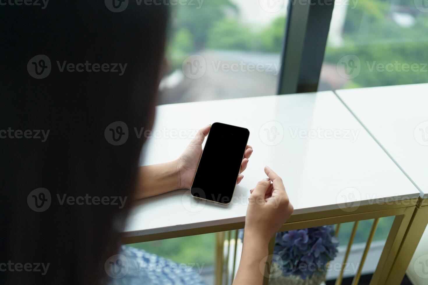 Close up of women's hands holding cell telephone blank copy space screen. smart phone with technology concept. photo