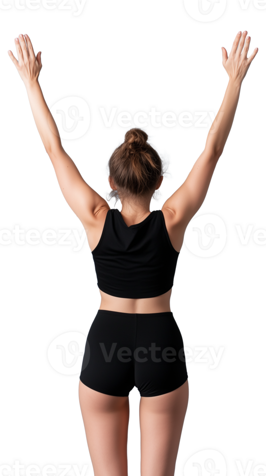 Fit woman in black sports outfit standing with arms raised in celebration on transparent background png