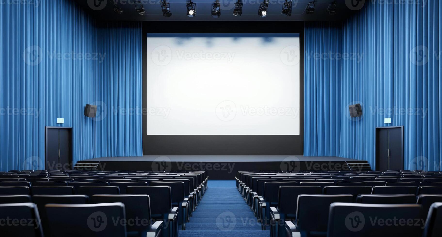 A cinema room with blue curtains. Front view of an empty white screen from the upper rows. photo