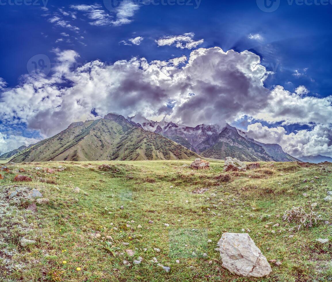 Scenic view of the Cross Pass in Georgia, showcasing lush green mountains and a winding valley photo