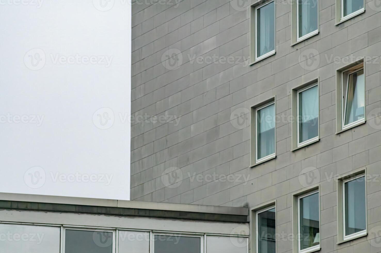 Modern building exterior with open window and grey facade photo