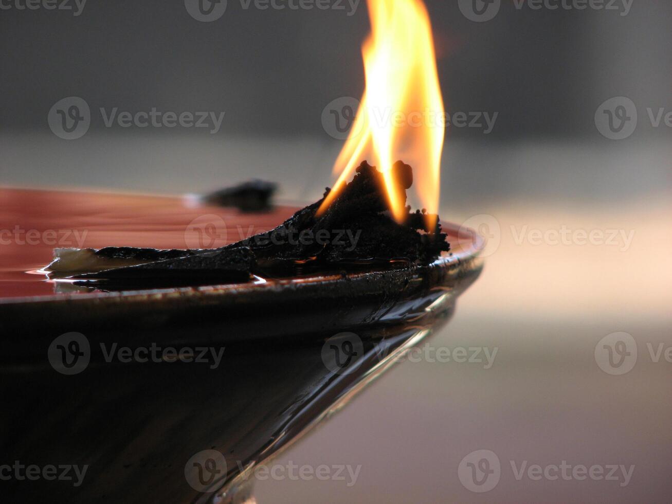Closeup of lighted traditional Indian oil lamp photo
