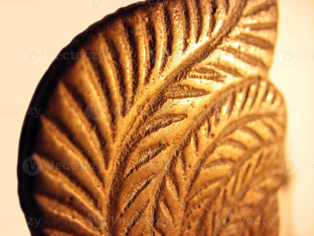 Closeup of engraving on an antique oil lamp photo