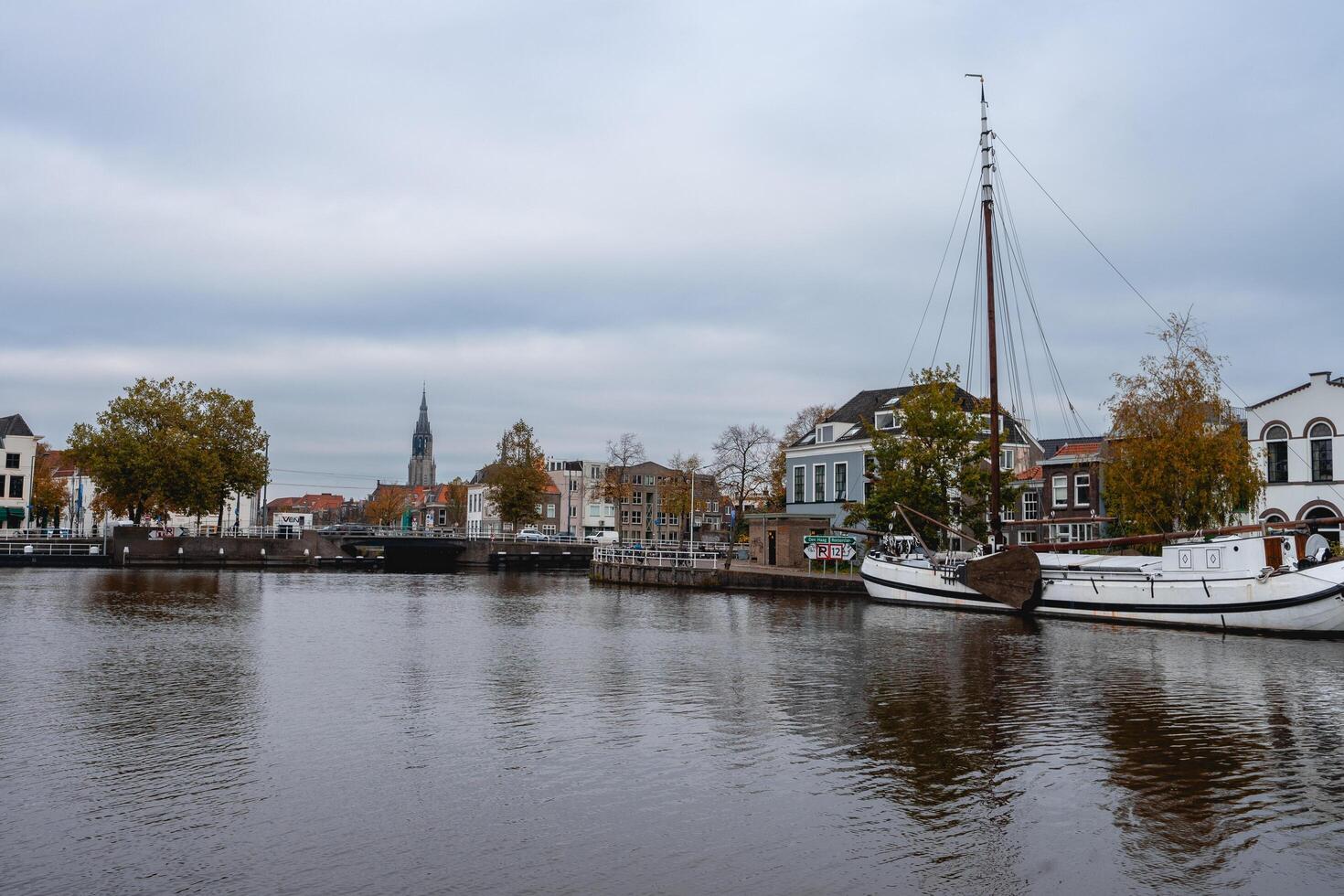 Delft, The Netherlands October 15, 2024. The harbour of Delft, with some old boats, and the skyline from the city. photo