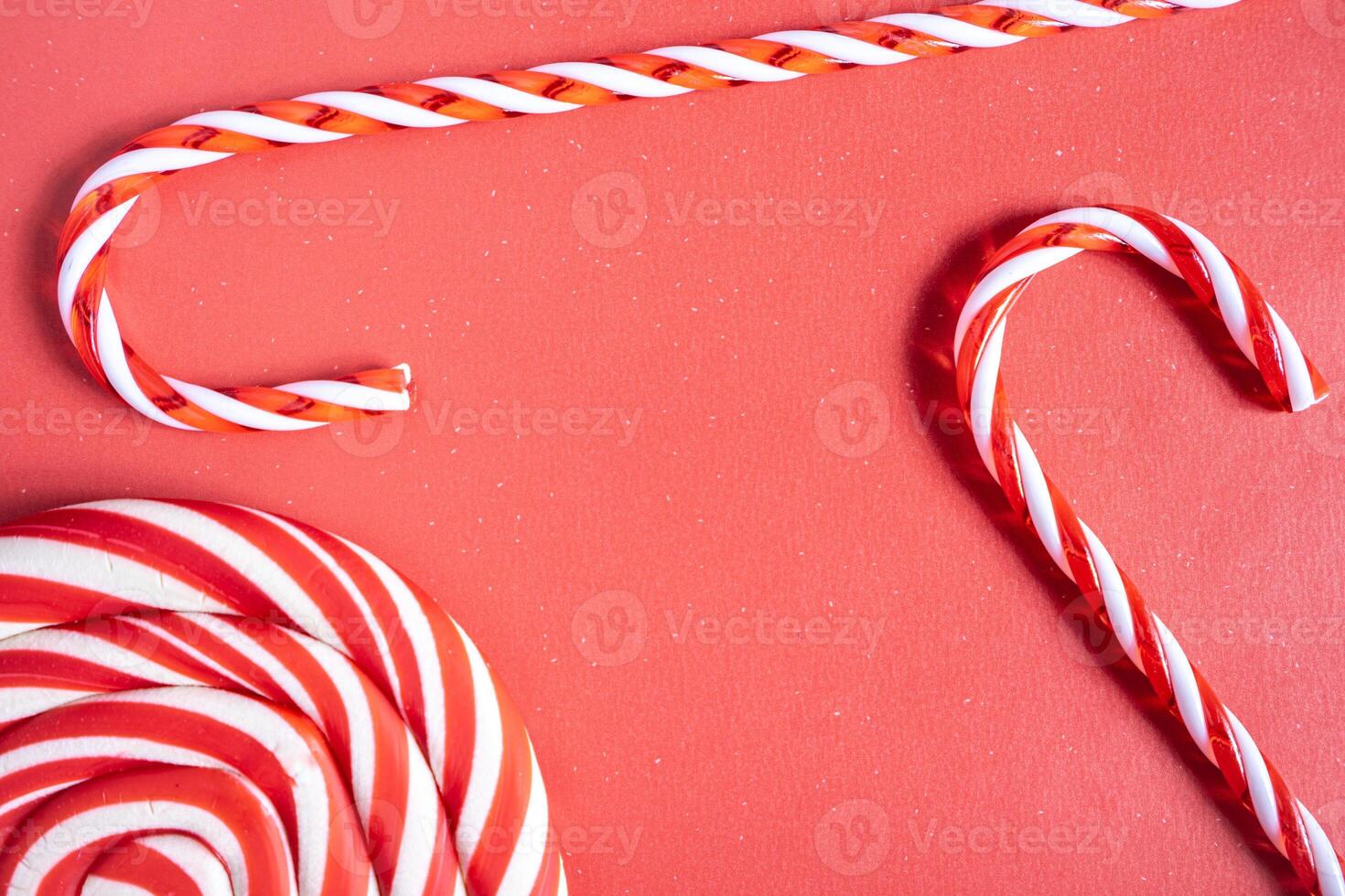 Christmas candy cane, and lollipop swirls. On a red background. photo