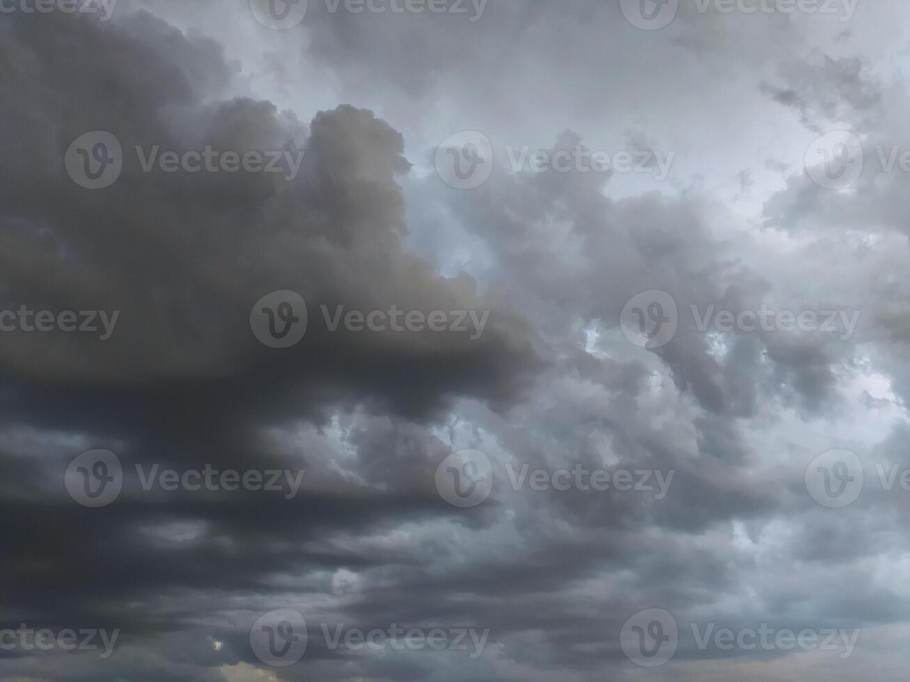 Dramatic cloud formation fills the sky during an overcast evening, hinting at an approaching storm photo