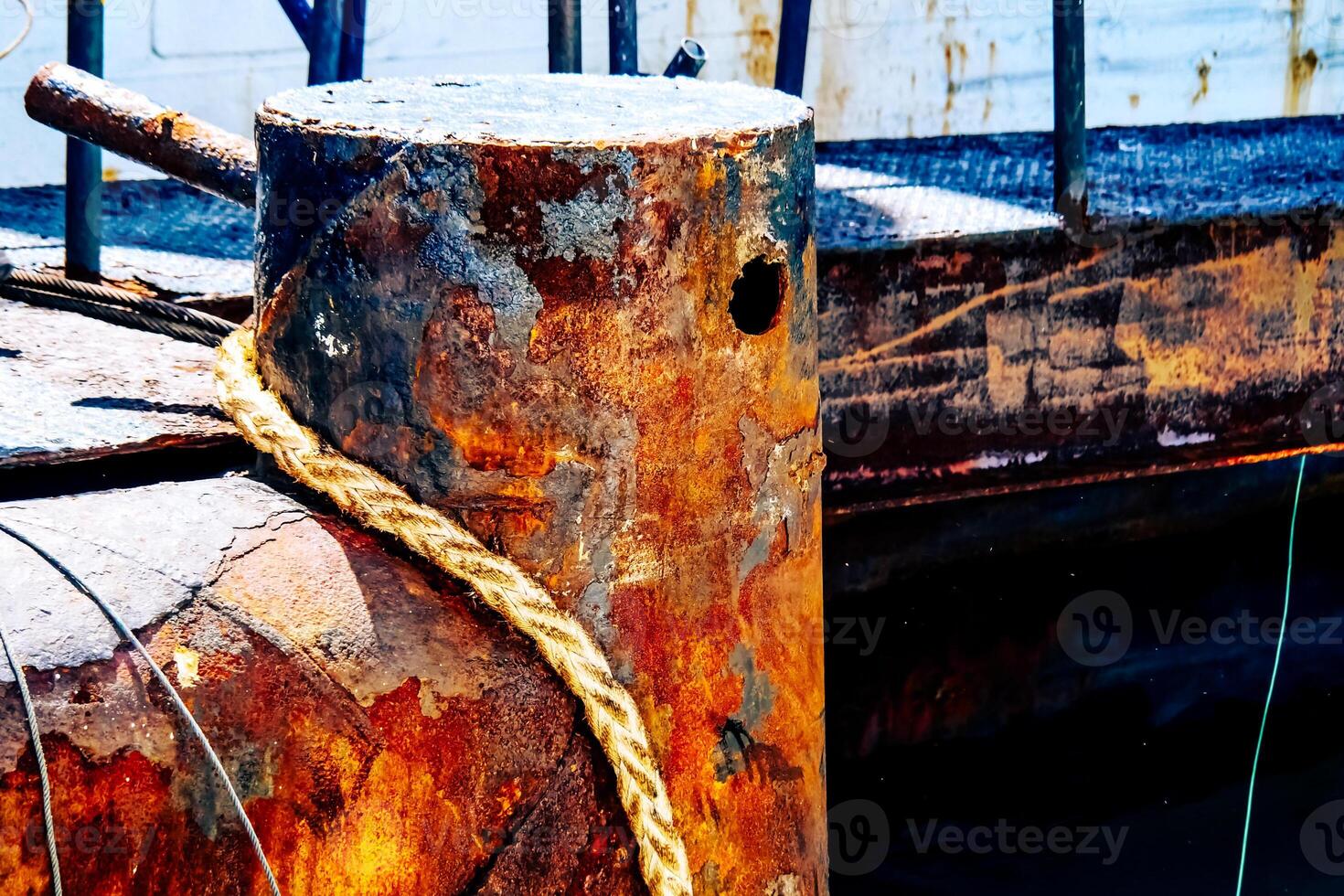 Rusty Industrial Dock with Weathered Metal and Rope in Vibrant Colors Capturing the Essence of Maritime Decay and Texture photo
