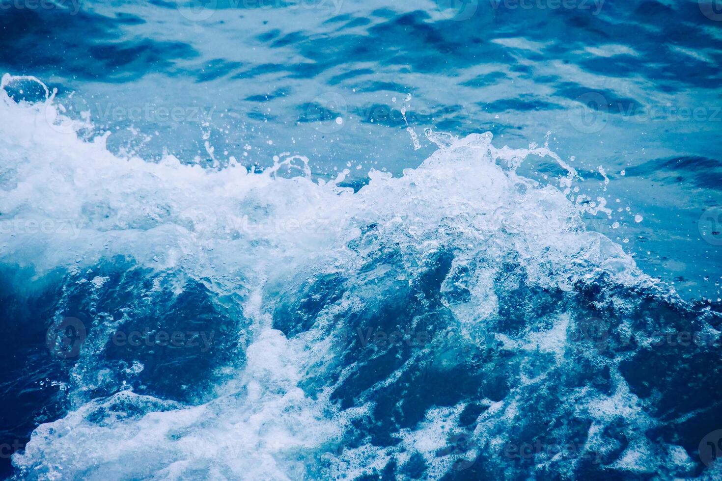 Dynamic Ocean Waves Crashing with Splashing Water and Vibrant Blue Tones Captured in Motion photo