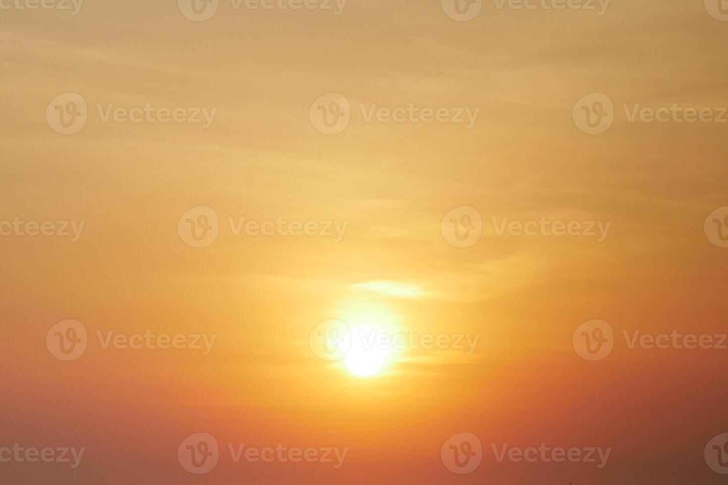 Stunning Golden Sunset with Vibrant Orange and Yellow Hues Creating a Serene and Tranquil Atmosphere in the Evening Sky photo