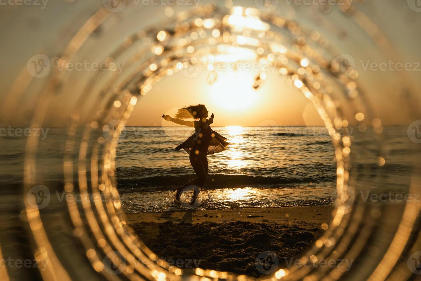 Woman Dancing at Sunset on a Beach photo