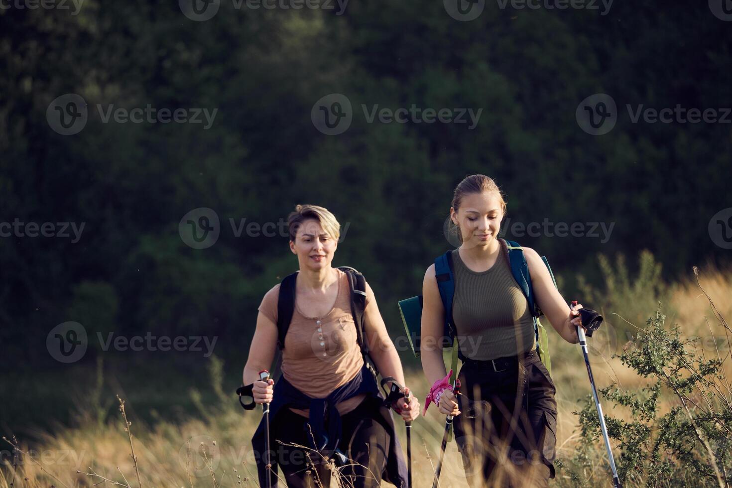 Mother And Daughter Hiking On Mountain photo