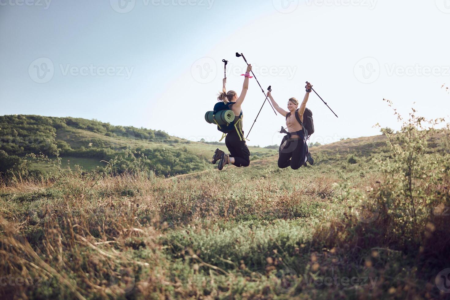 Two Women Having Fun After Getting On Top Of The Mountain photo