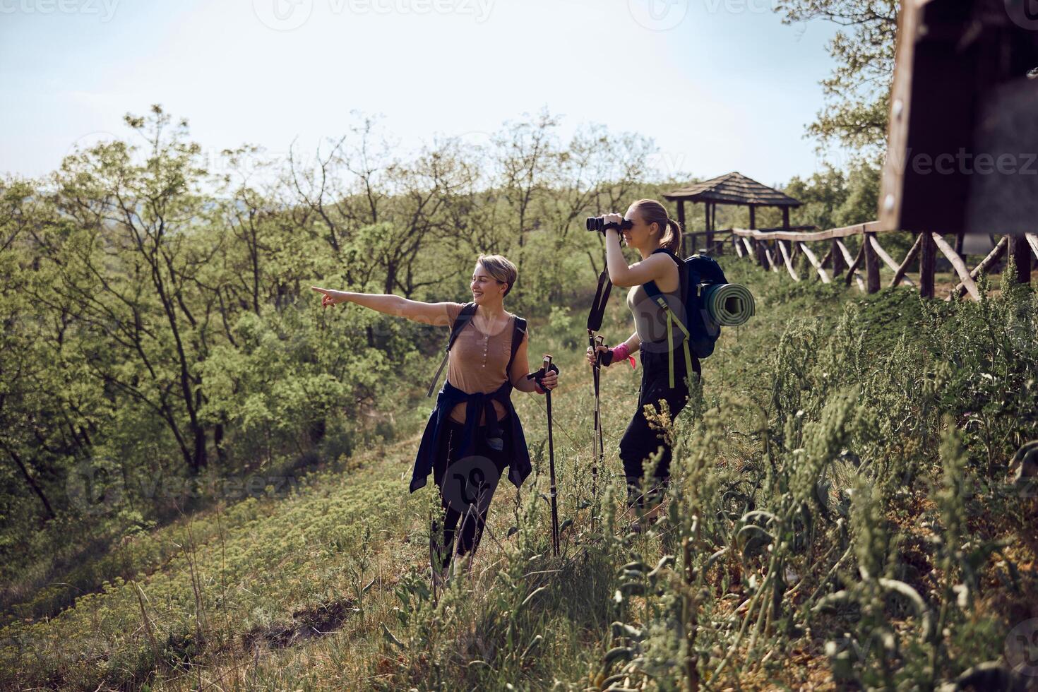 Mother And Daughter Using Binoculars While Hiking photo