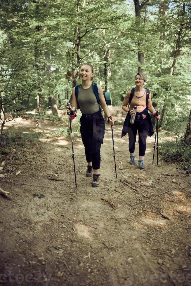 Mother And Daughter Hiking In The Forest photo