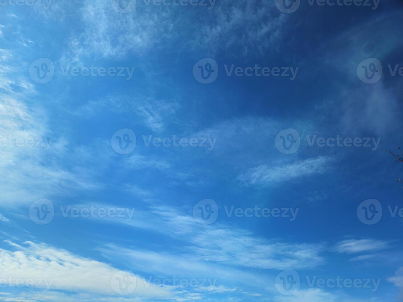 Horizontal view of a clear blue sky with light clouds, offering ample copy space. Ideal for website banners, social media backgrounds, or outdoor promotional materials. photo
