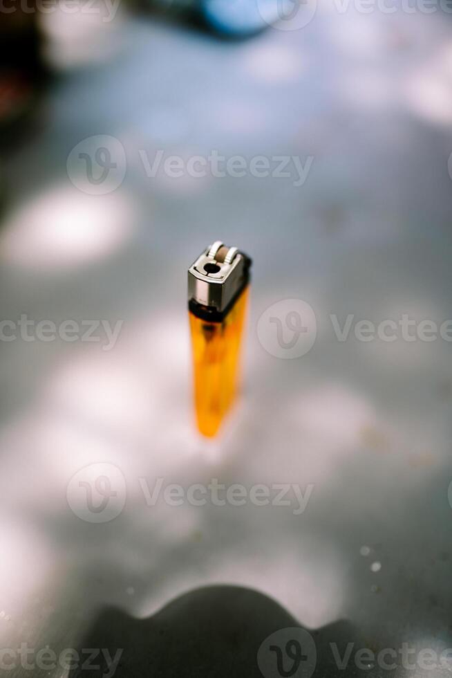 A close-up of a gas lighter, showcasing its sleek design and metal finish. photo