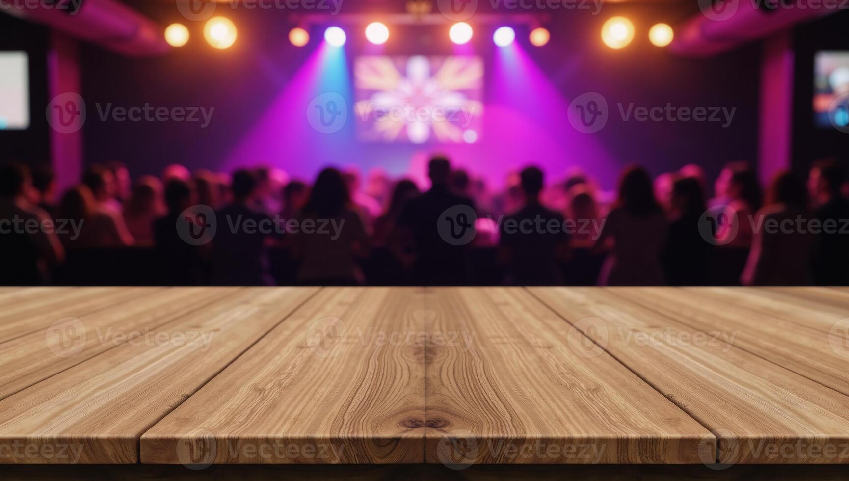 A blurred discoclub backdrop showcases an empty wooden table intended for product demonstrations photo