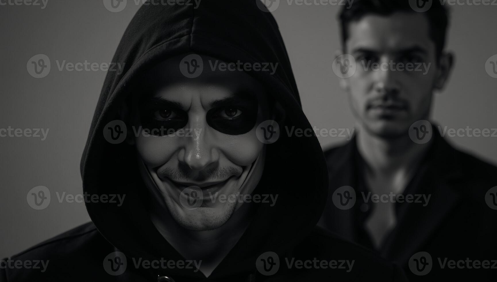 A Halloweeninspired image features a darkened setting with a hooded dangerous criminal lurking menacingly photo