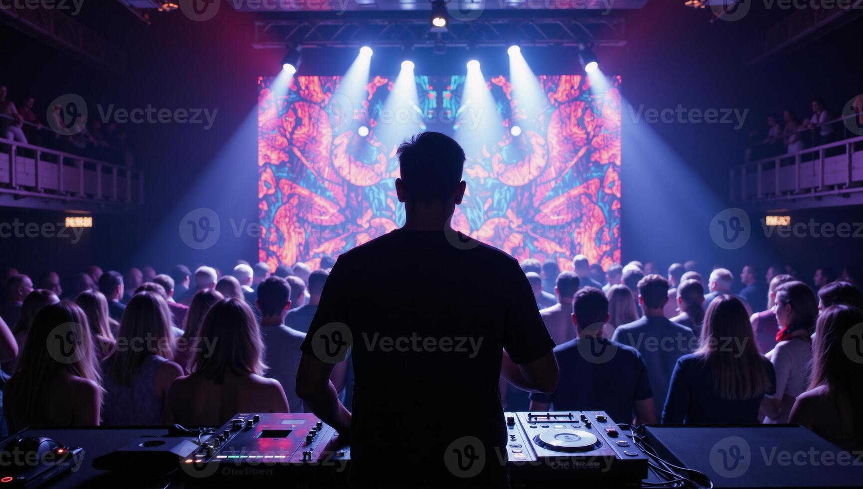 Vivid nightclub scene featuring DJs silhouette amidst kaleidoscopic light display enthusiastic audience photo