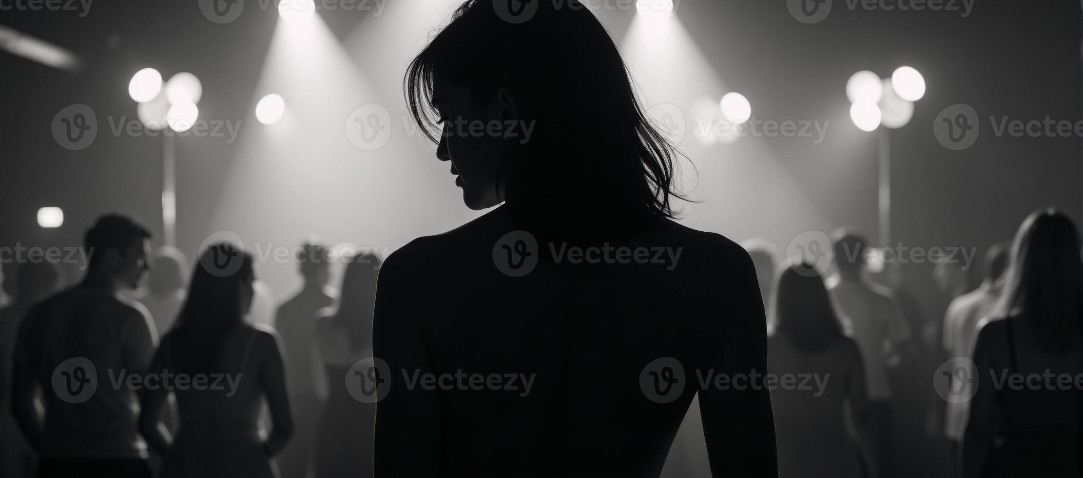Womans silhouette amidst bustling nightclub setting photo