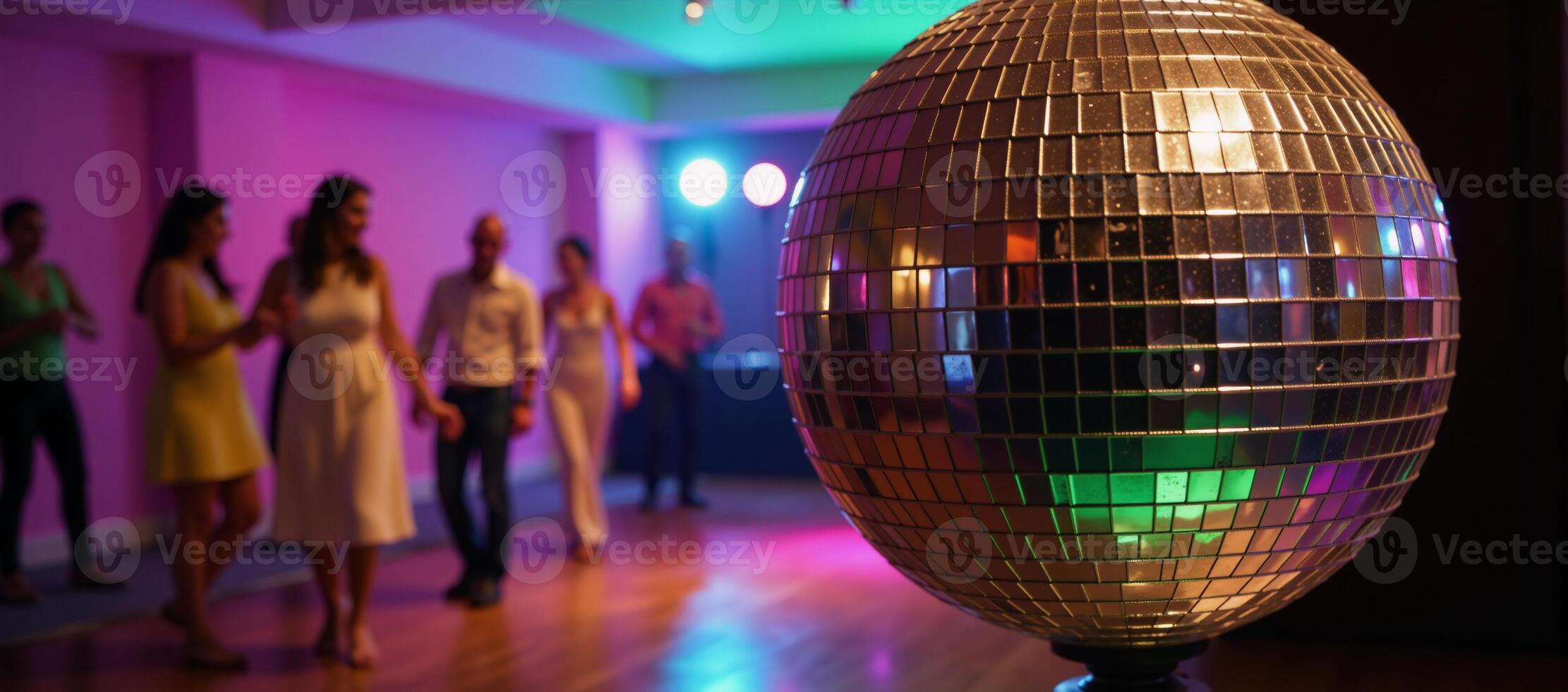 A disco ball illuminates a lively dance floor with soft musical beats photo