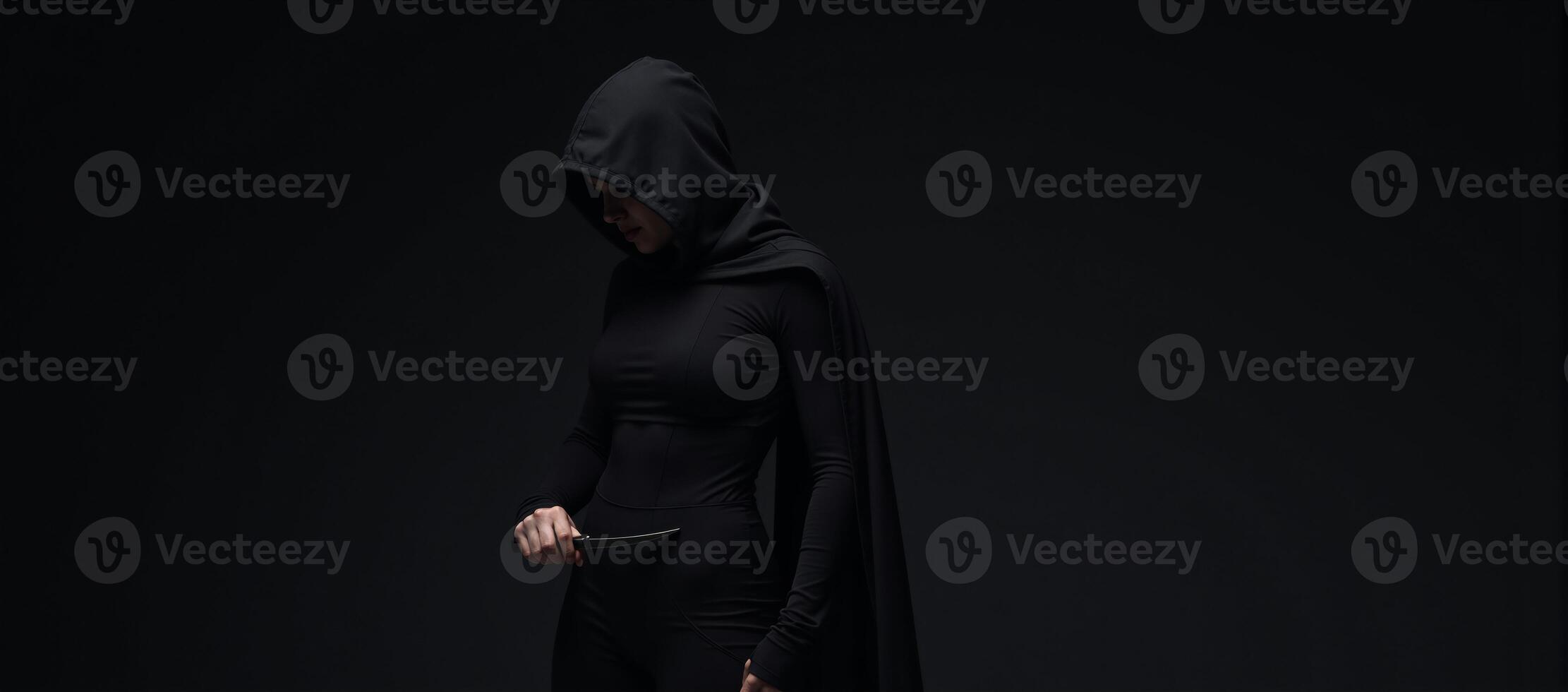 Mysterious hooded silent female rogue assassin photo