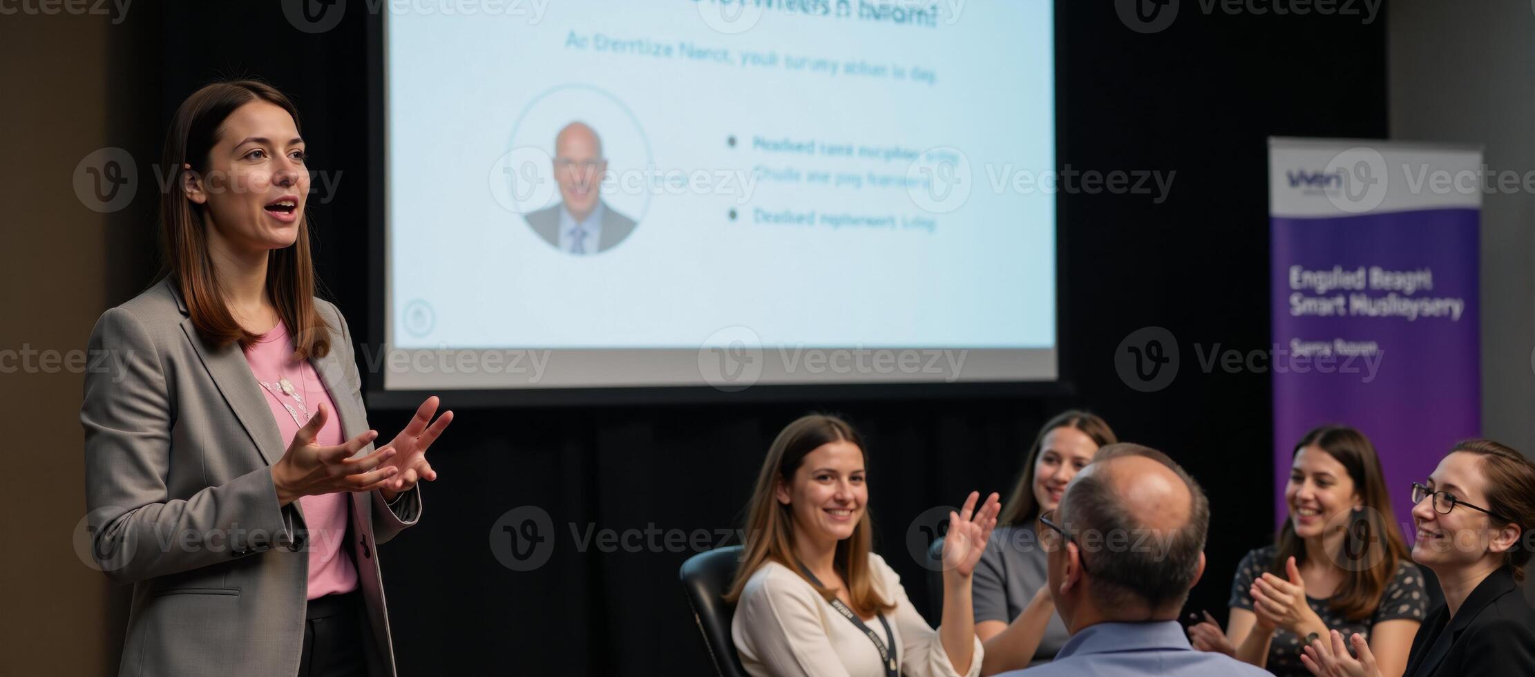 Businesswoman presenting startup idea to applauding smiling audience during speech photo