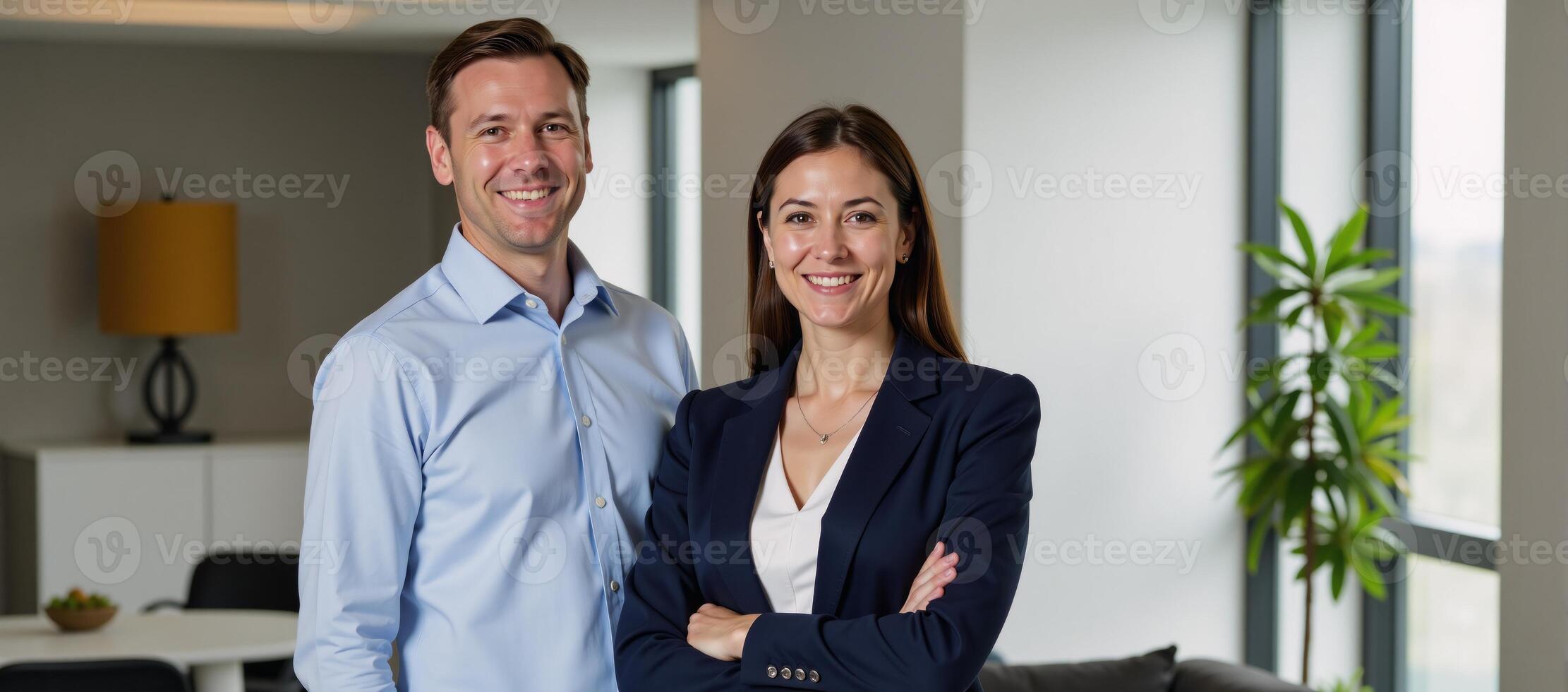 A diverse duo of smiling businesspeople pose together indoors photo