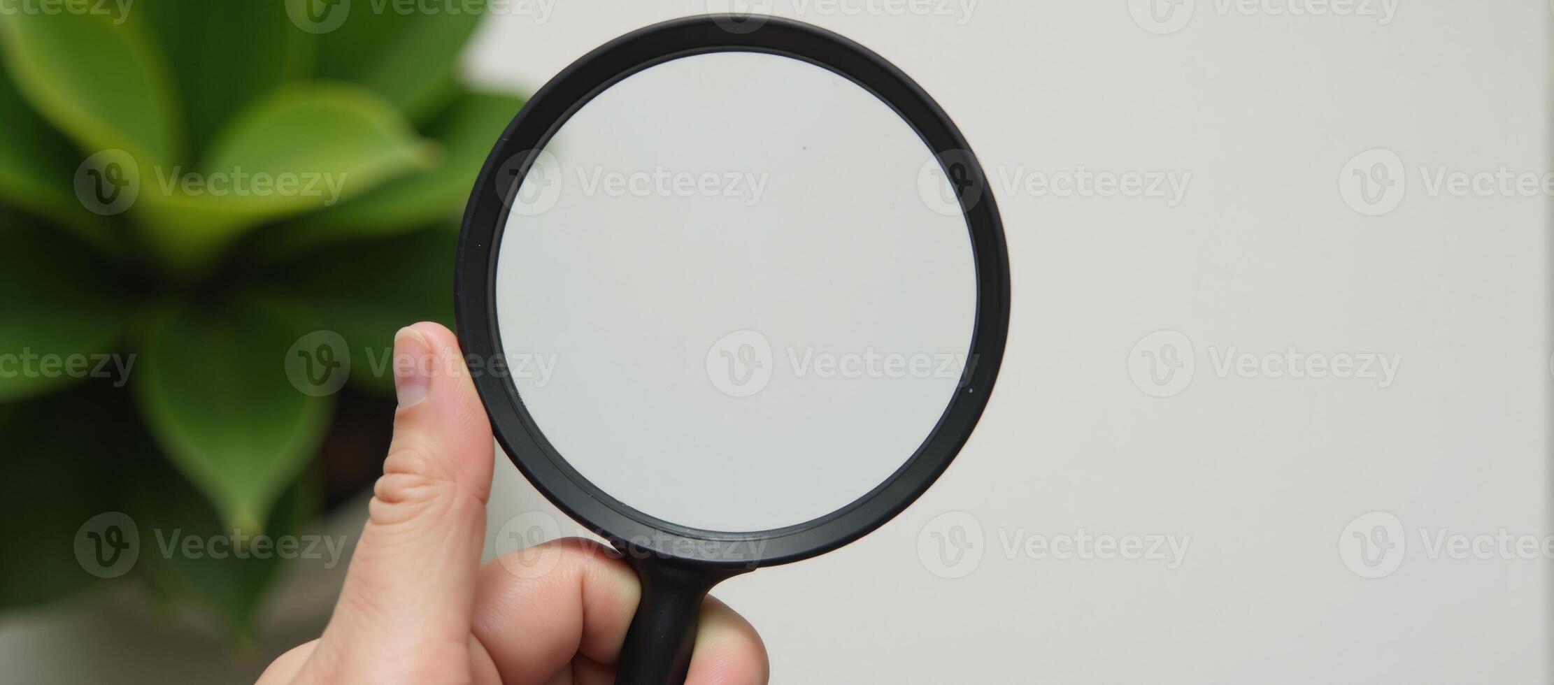 Hand checks for clean outdoor air using magnifying glass safe from pollutants dust PM 2 photo