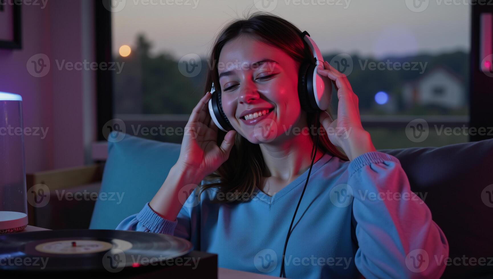 Girl enjoys relaxing with lofi visuals during evening music sessions photo