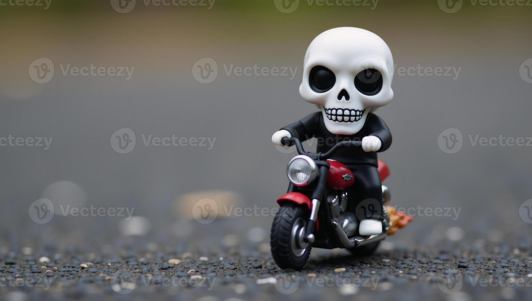 Small skullheaded humanoid figure on a flameadorned miniature motorbike photo