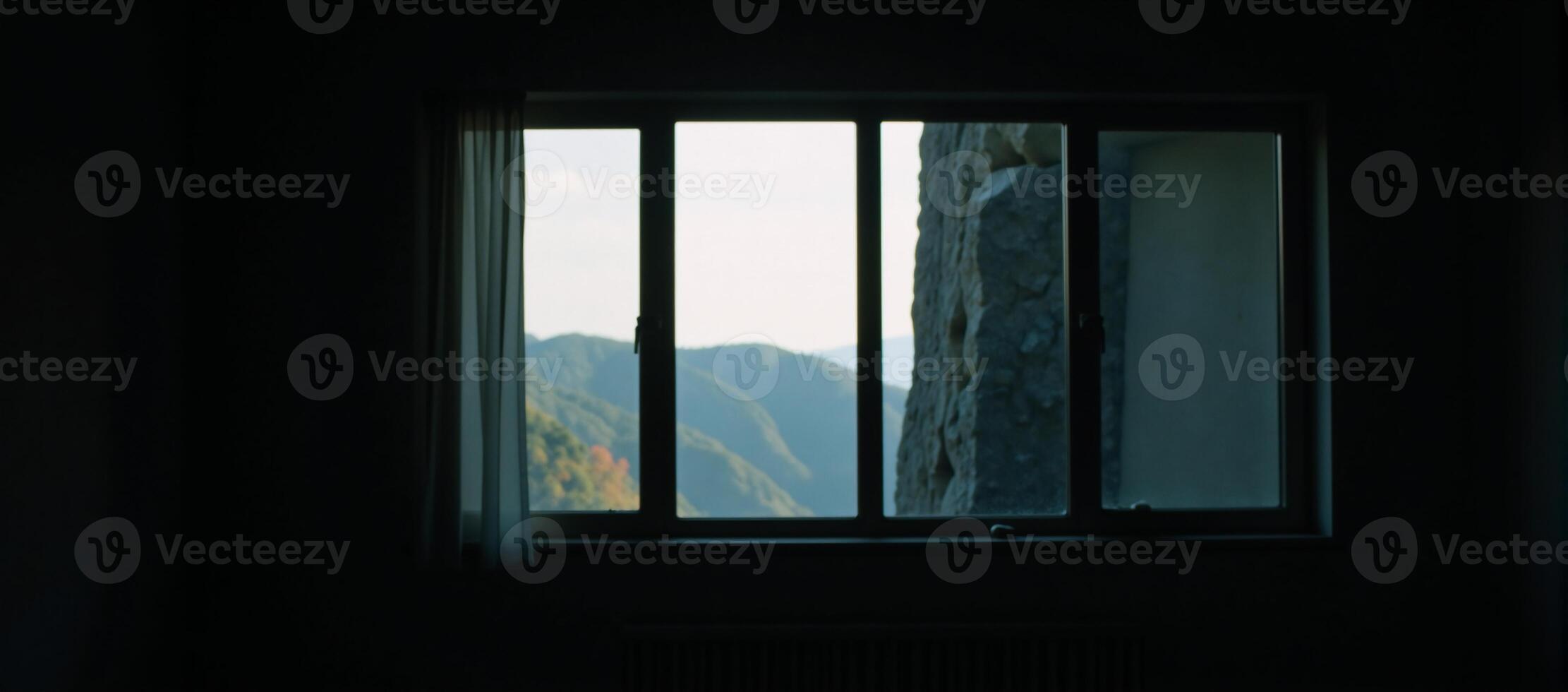 A dimly lit space featuring a large window photo