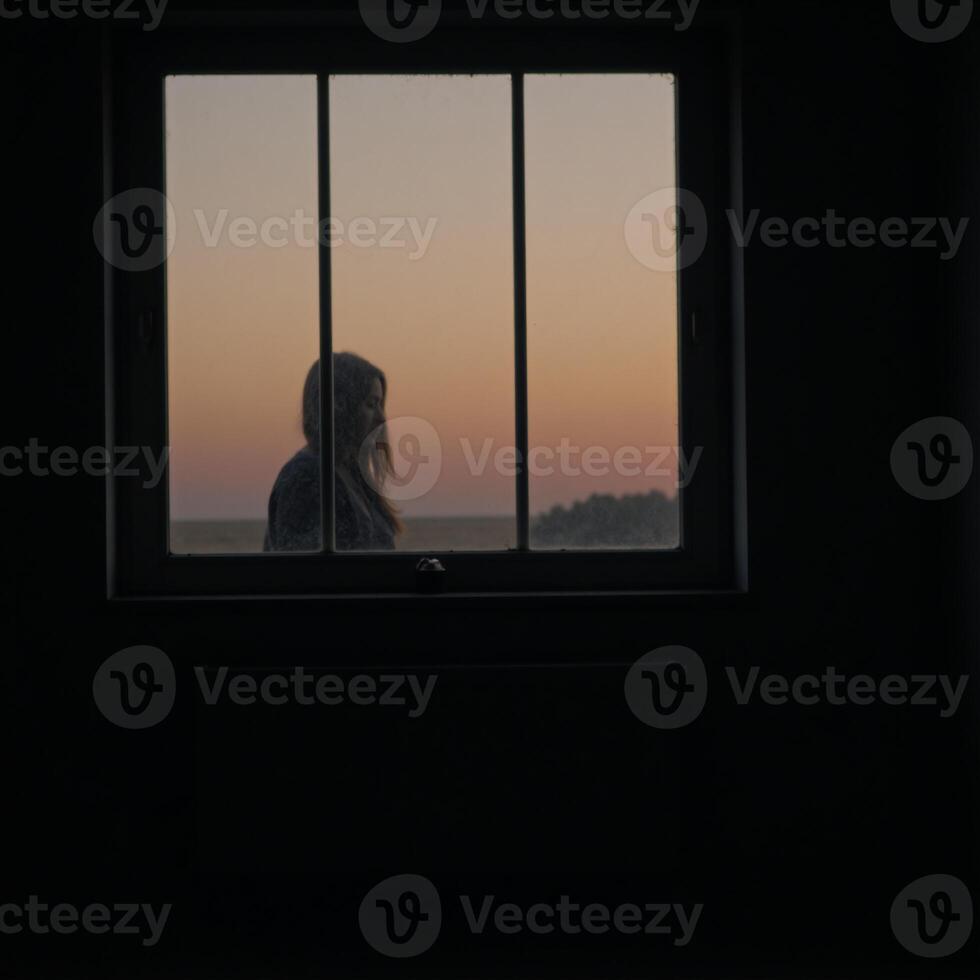 A dimly lit space featuring a large window photo