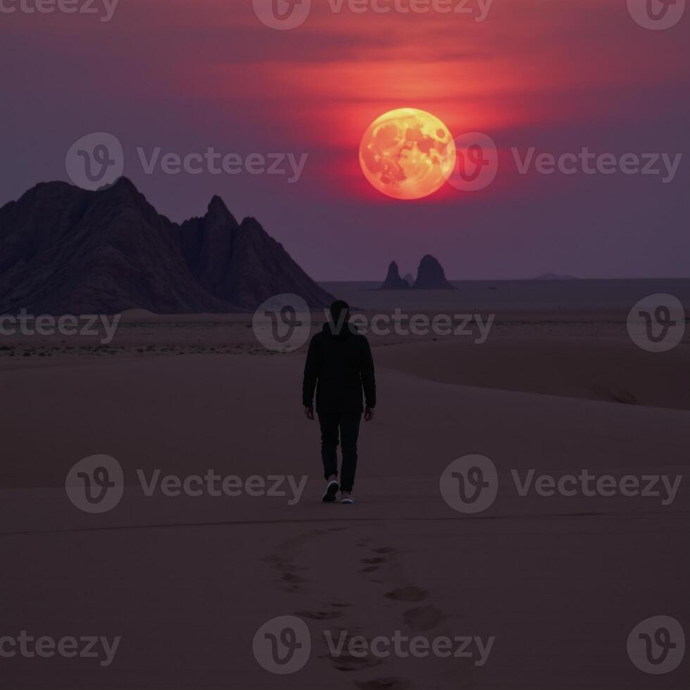 A solitary character traverses a barren desert under a bloodred moon photo