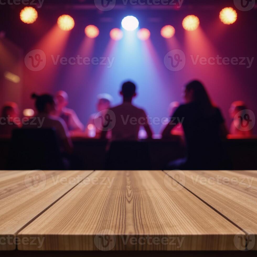 A blurred discoclub backdrop showcases an empty wooden table intended for product demonstrations photo