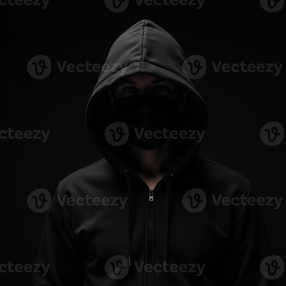Computer Hacker Blackhooded figure in Dark Moody Background photo