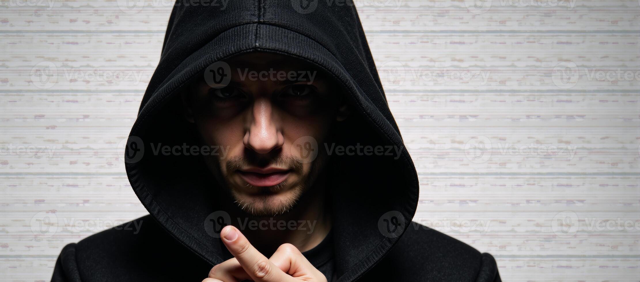 A hooded hacker amidst glitchy computer code glitch art photo
