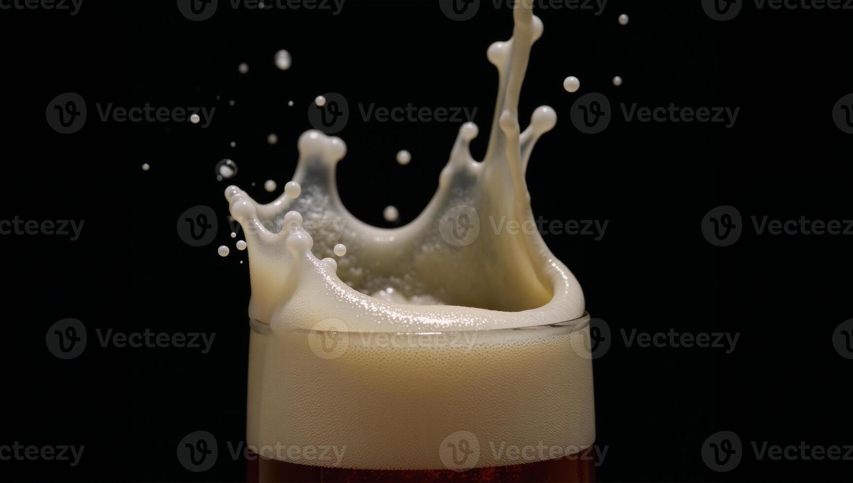 Slowmotion capture of a beer glass splash against a black backdrop photo