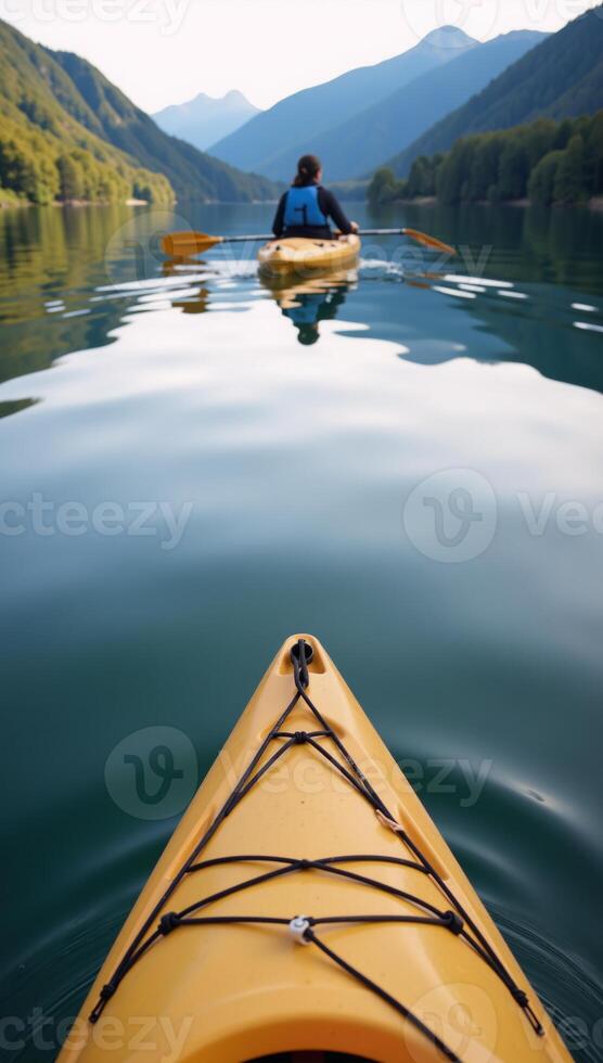 Person paddles a kayak on tranquil waters ideal for nature and exploration themes photo