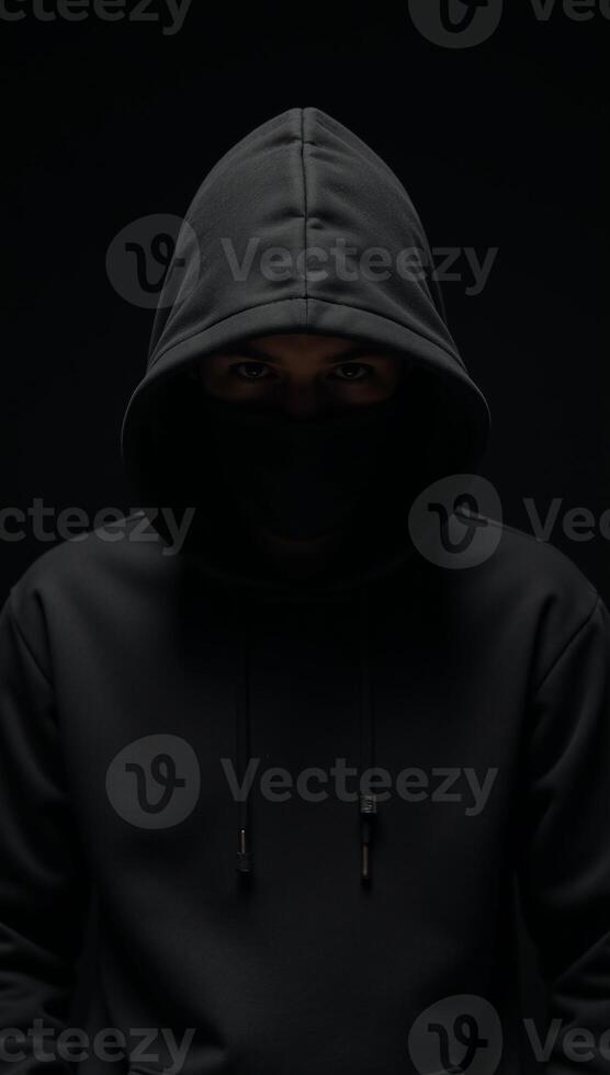 Computer Hacker Blackhooded figure in Dark Moody Background photo