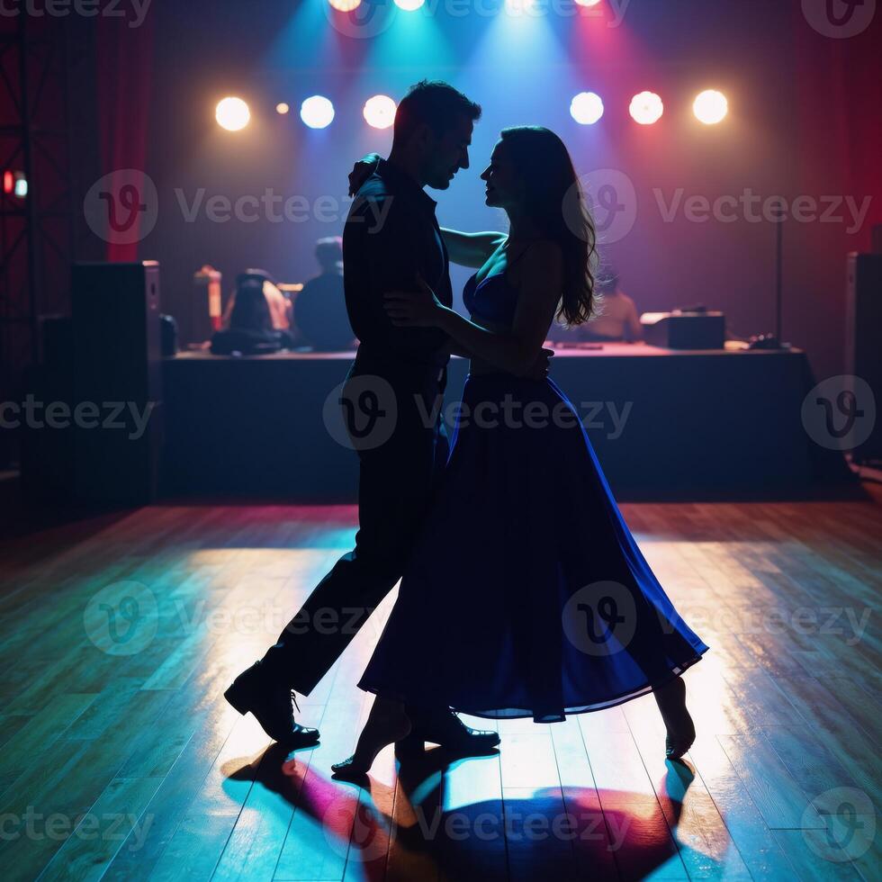 Couple silhouetted passionately dancing on a vibrant colorful dance floor photo
