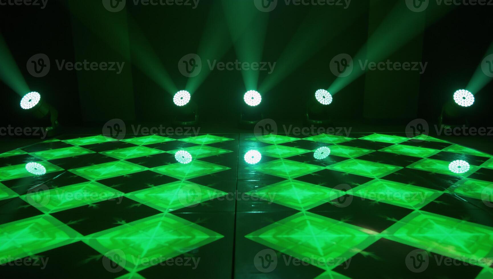 Vibrant dynamic stage setting with green lights and reflective geometric patterns for events or performances photo